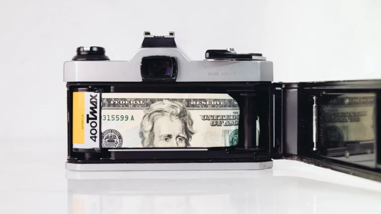 35mm film camera with 100 dollar bill inside of the camera