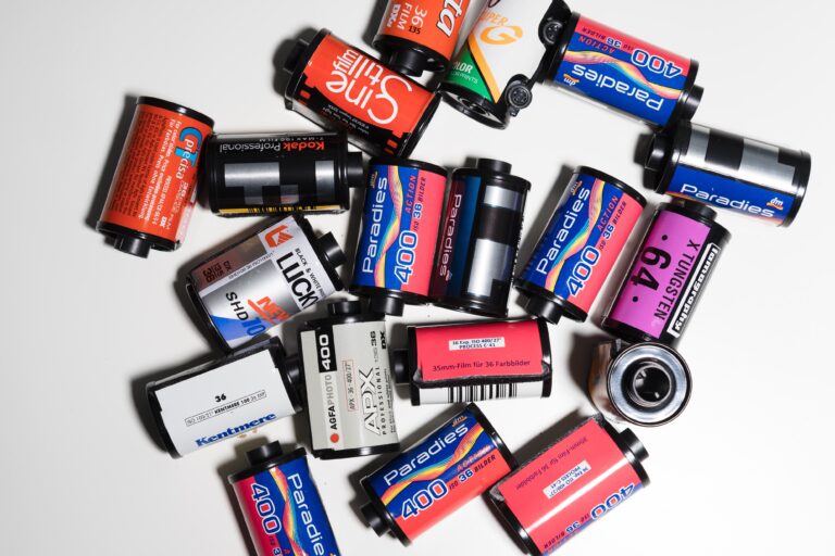 Various rolls of film for 35mm film photography on a white desk